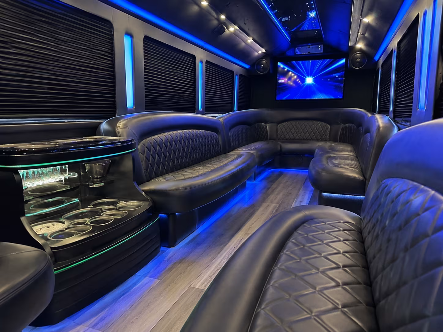 Friends laughing during a party bus celebration in Tucson
