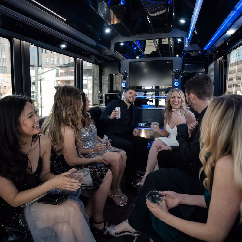 Party bus interior with wraparound leather seating and LED lighting in Tucson