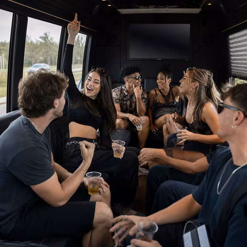 Group boarding a white charter bus for Concert Transportation transportation in Tucson
