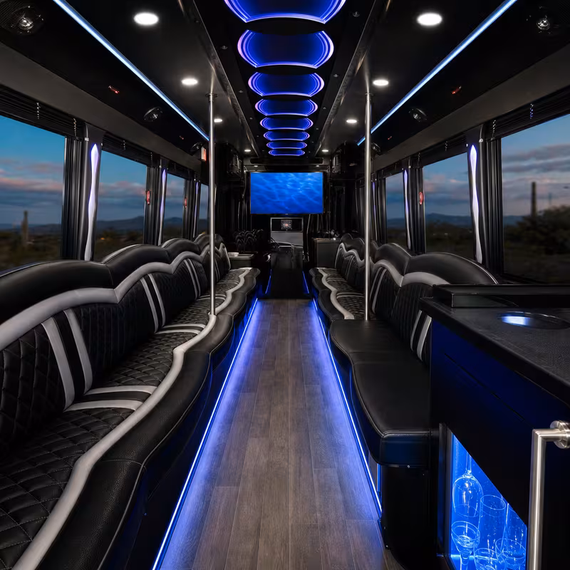 Party bus interior with wraparound leather seating and LED lighting in Tucson